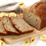 Golden-brown banana bread loaf on a cooling rack